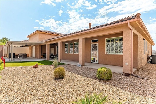 3811 Queen Elizabeth Ct, Laughlin, NV 89029 - back of house with ceiling fan, stucco siding, central air condition unit, and a patio area