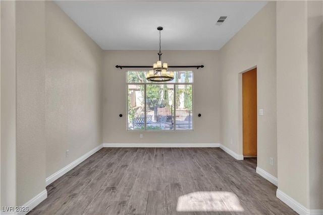 1717 Double Arch Ct, Las Vegas, NV 89128 - spare room with a chandelier and wood finished floors