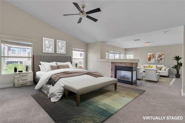 1717 Double Arch Ct, Las Vegas, NV 89128 - carpeted bedroom with multiple windows, a fireplace, vaulted ceiling, and a ceiling fan