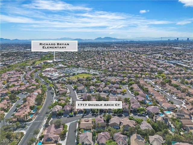 1717 Double Arch Ct, Las Vegas, NV 89128 - aerial view of property and surrounding area featuring a mountainous background and nearby suburban area
