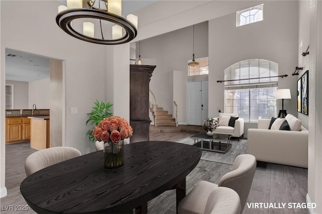 1717 Double Arch Ct, Las Vegas, NV 89128 - living area with a high ceiling, wood finished floors, healthy amount of natural light, and stairway