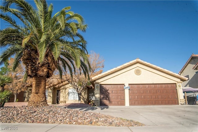 3436 N Tenaya Way, Las Vegas, NV 89129 - ranch-style house with concrete driveway, stucco siding, an attached garage, and a tiled roof