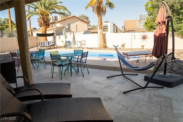 3436 N Tenaya Way, Las Vegas, NV 89129 - view of swimming pool featuring a fenced backyard, a patio, and outdoor dining space