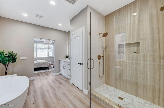 2714 Langlade Ave, Henderson, NV 89052 - ensuite bathroom featuring a stall shower, a freestanding tub, wood finished floors, and recessed lighting
