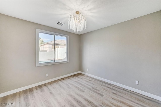 2714 Langlade Ave, Henderson, NV 89052 - spare room with a chandelier and light wood-style floors