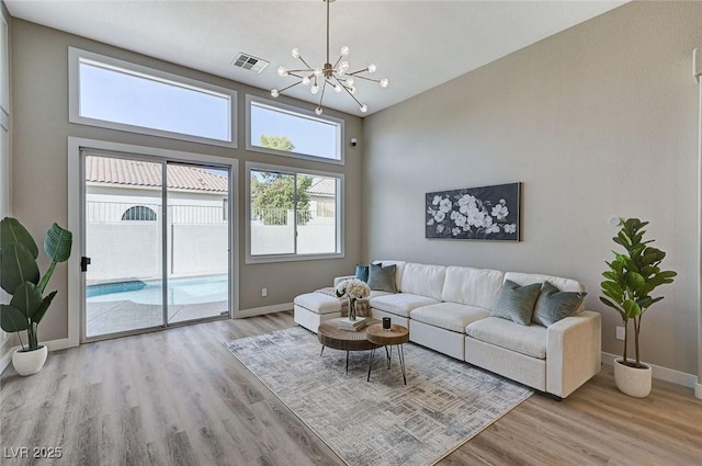 2714 Langlade Ave, Henderson, NV 89052 - living room featuring wood finished floors, healthy amount of natural light, and a chandelier