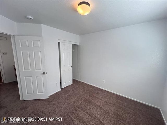 7464 Edgecove Ct, Las Vegas, NV 89139 - unfurnished bedroom featuring dark colored carpet, a closet, and baseboards