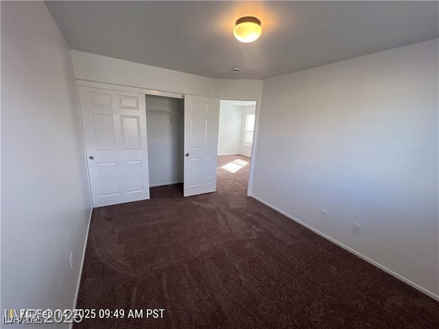 7464 Edgecove Ct, Las Vegas, NV 89139 - unfurnished bedroom with baseboards, dark carpet, and a closet