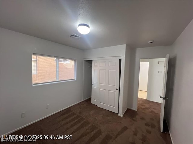7464 Edgecove Ct, Las Vegas, NV 89139 - unfurnished bedroom featuring dark carpet, a closet, and baseboards