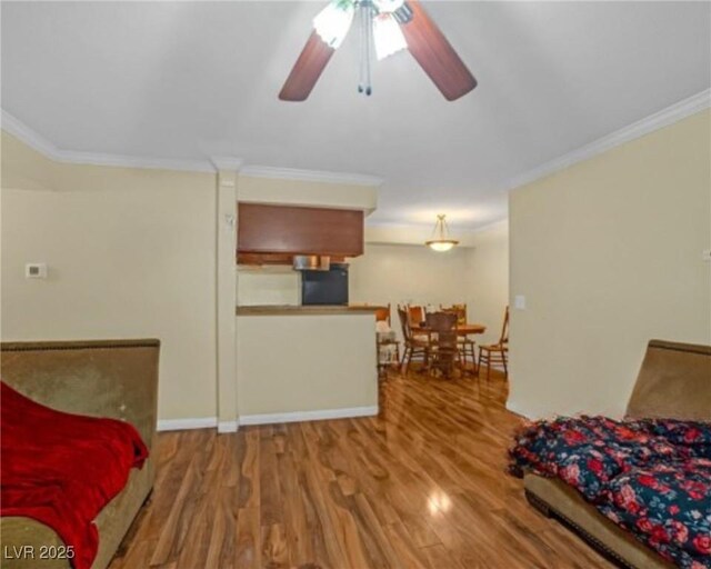 3135 S Mojave Rd Unit 113, Las Vegas, NV 89121 - living room featuring a ceiling fan, wood finished floors, and ornamental molding