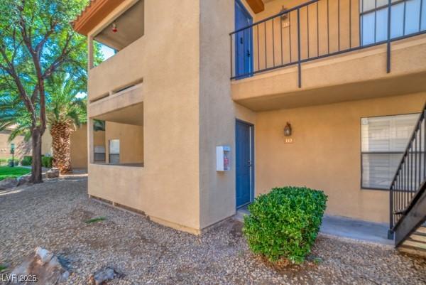 3135 S Mojave Rd Unit 113, Las Vegas, NV 89121 - view of property exterior with stucco siding and a balcony