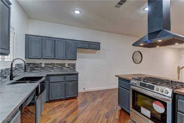 108 Broken Rock Dr, Henderson, NV 89074 - kitchen with stainless steel range with gas stovetop, wall chimney range hood, dark wood-style flooring, backsplash, and dishwashing machine