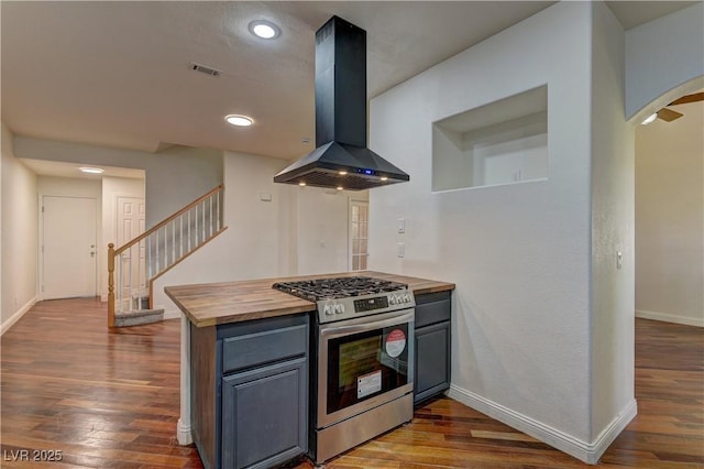 108 Broken Rock Dr, Henderson, NV 89074 - kitchen featuring extractor fan, stainless steel range with gas stovetop, wood counters, arched walkways, and dark wood-style floors