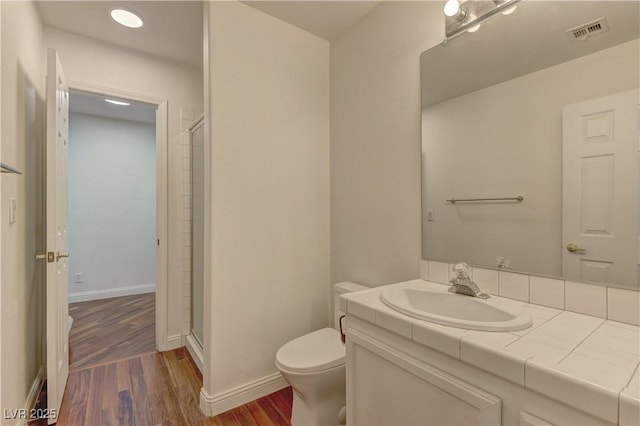 108 Broken Rock Dr, Henderson, NV 89074 - full bathroom featuring wood finished floors, vanity, and a shower with shower door