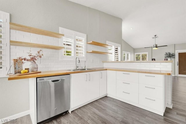3053 Anchor Chain Dr, Las Vegas, NV 89128 - kitchen with stainless steel dishwasher, open shelves, a sink, a peninsula, and wood finished floors