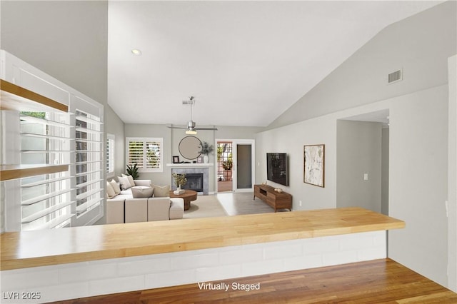 3053 Anchor Chain Dr, Las Vegas, NV 89128 - living room with a fireplace and high vaulted ceiling