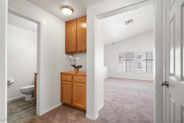 5201 S Torrey Pines Dr Unit 1221, Las Vegas, NV 89118 - hallway with light colored carpet, baseboards, and lofted ceiling