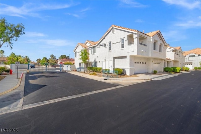 5201 S Torrey Pines Dr Unit 1221, Las Vegas, NV 89118 - view of asphalt street with a residential view, a gate, sidewalks, curbs, and a gated entry