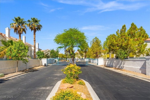 5201 S Torrey Pines Dr Unit 1221, Las Vegas, NV 89118 - view of asphalt street with a gate, curbs, and a gated entry