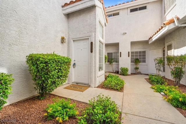 5201 S Torrey Pines Dr Unit 1221, Las Vegas, NV 89118 - view of exterior entry with a tile roof and stucco siding