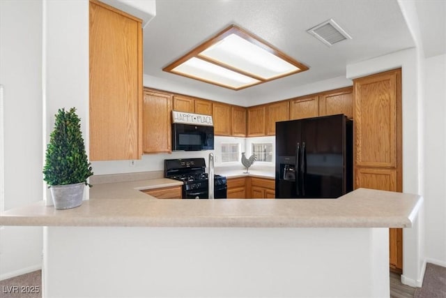 5201 S Torrey Pines Dr Unit 1221, Las Vegas, NV 89118 - kitchen featuring black appliances, light countertops, a peninsula, and baseboards