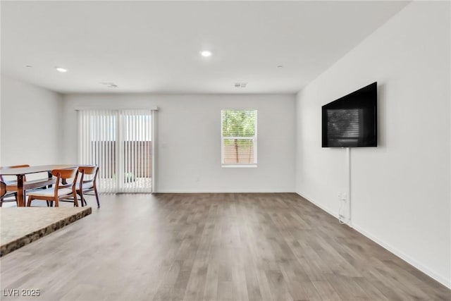 7977 Whisper Words Ave, Las Vegas, NV 89113 - unfurnished living room featuring wood finished floors, recessed lighting, and baseboards