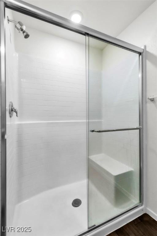 7977 Whisper Words Ave, Las Vegas, NV 89113 - bathroom featuring a stall shower and wood finished floors