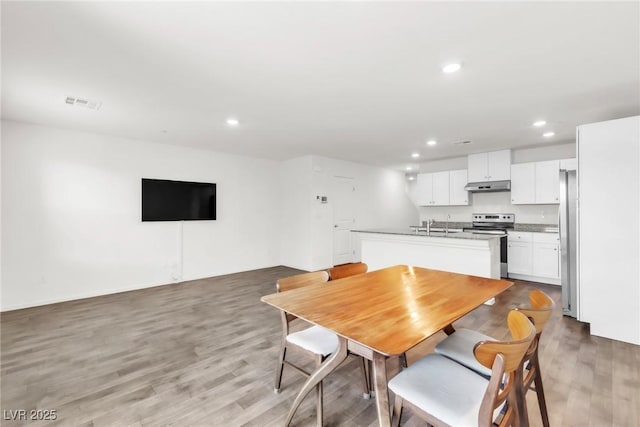 7977 Whisper Words Ave, Las Vegas, NV 89113 - dining space featuring light wood finished floors and recessed lighting