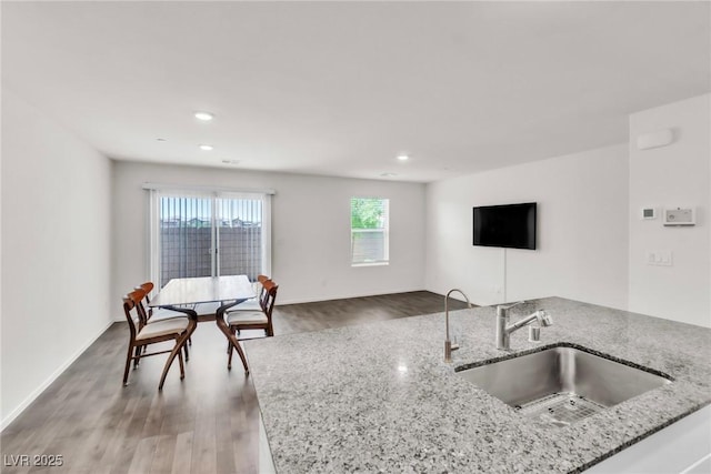 7977 Whisper Words Ave, Las Vegas, NV 89113 - kitchen with a sink, wood finished floors, open floor plan, light stone countertops, and recessed lighting
