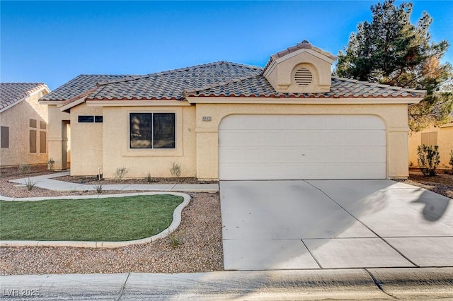 6143 Basilone Ave, Las Vegas, NV 89122 - mediterranean / spanish-style house with driveway, stucco siding, a tile roof, and an attached garage