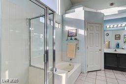 6143 Basilone Ave, Las Vegas, NV 89122 - full bathroom featuring vanity, a bath, tile patterned floors, and a shower stall