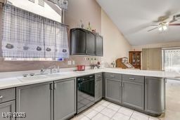6143 Basilone Ave, Las Vegas, NV 89122 - kitchen featuring gray cabinets, lofted ceiling, black dishwasher, a peninsula, and a ceiling fan