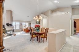 6143 Basilone Ave, Las Vegas, NV 89122 - dining space featuring vaulted ceiling and a chandelier
