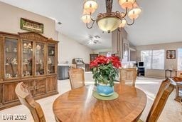6143 Basilone Ave, Las Vegas, NV 89122 - dining space featuring a chandelier and vaulted ceiling