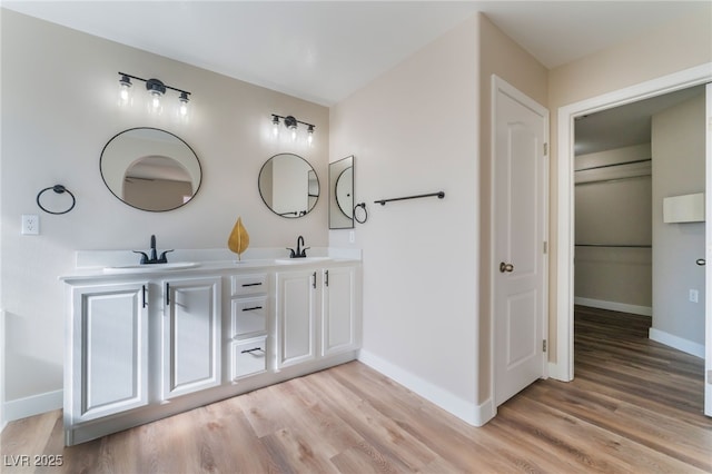 1512 Groom Ave, North Las Vegas, NV 89081 - bathroom featuring wood finished floors, double vanity, and baseboards