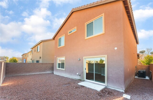 1512 Groom Ave, North Las Vegas, NV 89081 - rear view of house with stucco siding, a fenced backyard, and central air condition unit