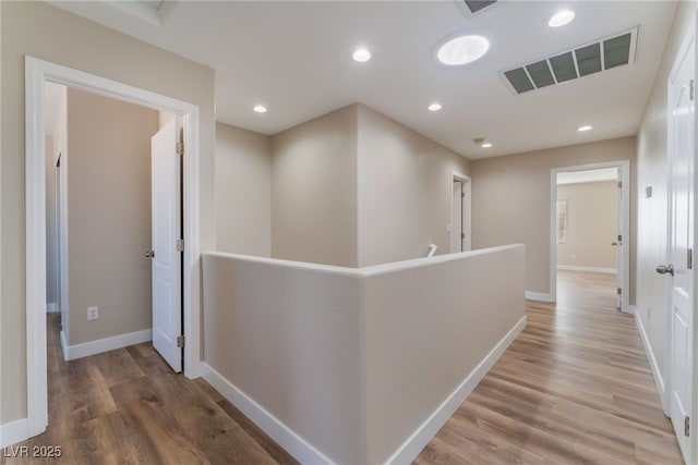 1512 Groom Ave, North Las Vegas, NV 89081 - hallway with light wood-style flooring, an upstairs landing, baseboards, and recessed lighting