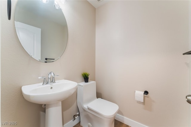 1512 Groom Ave, North Las Vegas, NV 89081 - bathroom with toilet, wood finished floors, and baseboards