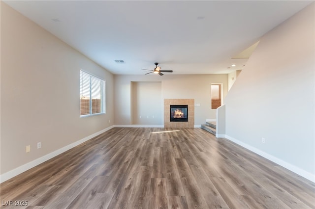 1512 Groom Ave, North Las Vegas, NV 89081 - unfurnished living room featuring a ceiling fan, wood finished floors, baseboards, and a tiled fireplace