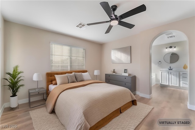 1512 Groom Ave, North Las Vegas, NV 89081 - bedroom featuring light wood-style flooring, arched walkways, baseboards, and ceiling fan