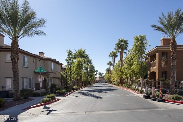 10291 Delta View Ct Unit 101, Las Vegas, NV 89129 - view of concrete street featuring curbs, traffic signs, and sidewalks