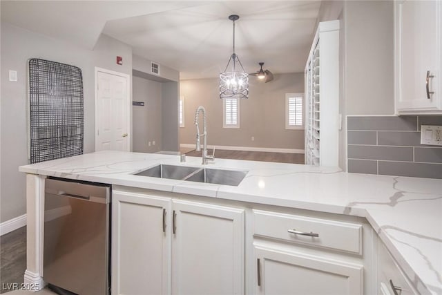10291 Delta View Ct Unit 101, Las Vegas, NV 89129 - kitchen with dishwasher, a sink, white cabinets, decorative backsplash, and light stone counters