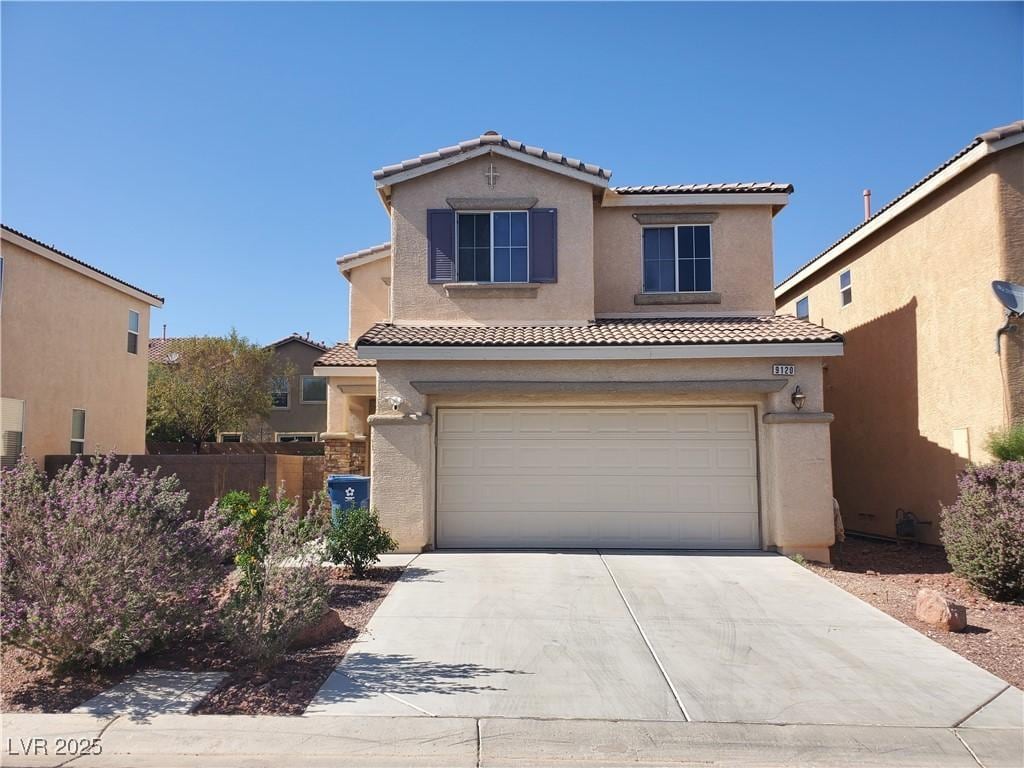 9120 Landons Point Ct, Las Vegas, NV 89148 - view of front of home with a tiled roof, stucco siding, an attached garage, and driveway