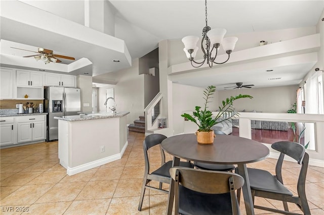 2080 Silver Breeze Ave, Las Vegas, NV 89183 - dining room with a ceiling fan, light tile patterned flooring, a chandelier, stairway, and baseboards