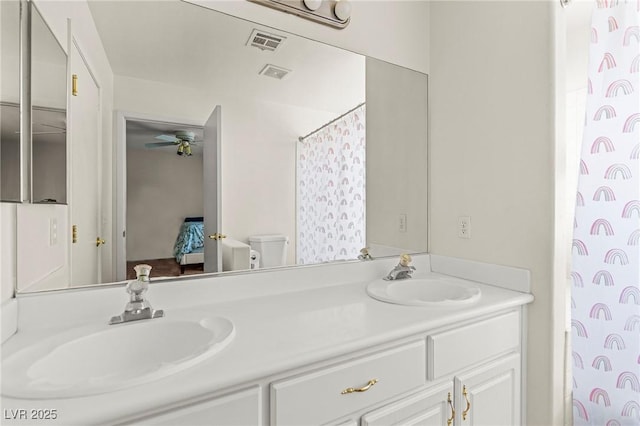 2080 Silver Breeze Ave, Las Vegas, NV 89183 - full bath with double vanity, connected bathroom, toilet, and ceiling fan