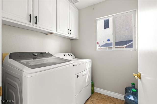 2080 Silver Breeze Ave, Las Vegas, NV 89183 - laundry room featuring separate washer and dryer, cabinet space, baseboards, and light tile patterned floors
