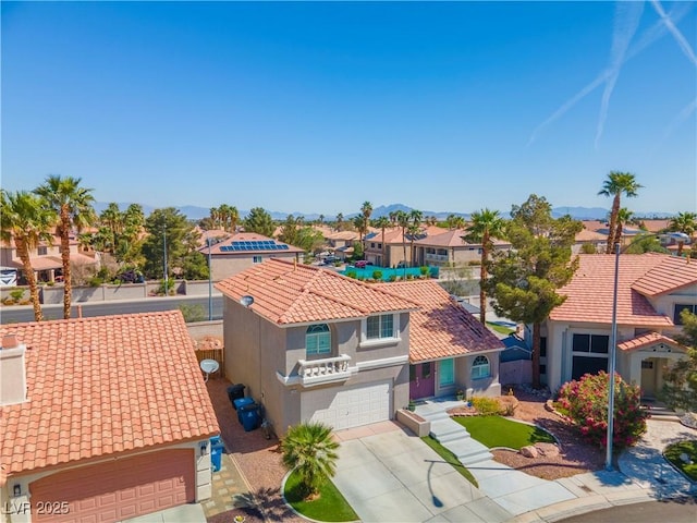 2080 Silver Breeze Ave, Las Vegas, NV 89183 - view of front of home with a residential view, a tiled roof, stucco siding, an attached garage, and a mountain view