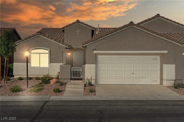 11082 Sospel Pl, Las Vegas, NV 89141 - view of front of property featuring a garage, stucco siding, a tiled roof, and driveway