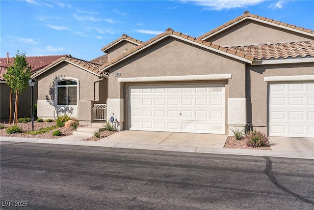 11082 Sospel Pl, Las Vegas, NV 89141 - mediterranean / spanish-style home with a garage, stucco siding, driveway, and a tiled roof