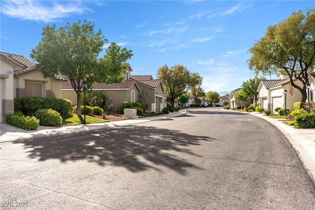 11082 Sospel Pl, Las Vegas, NV 89141 - view of asphalt road featuring a residential view, curbs, and sidewalks